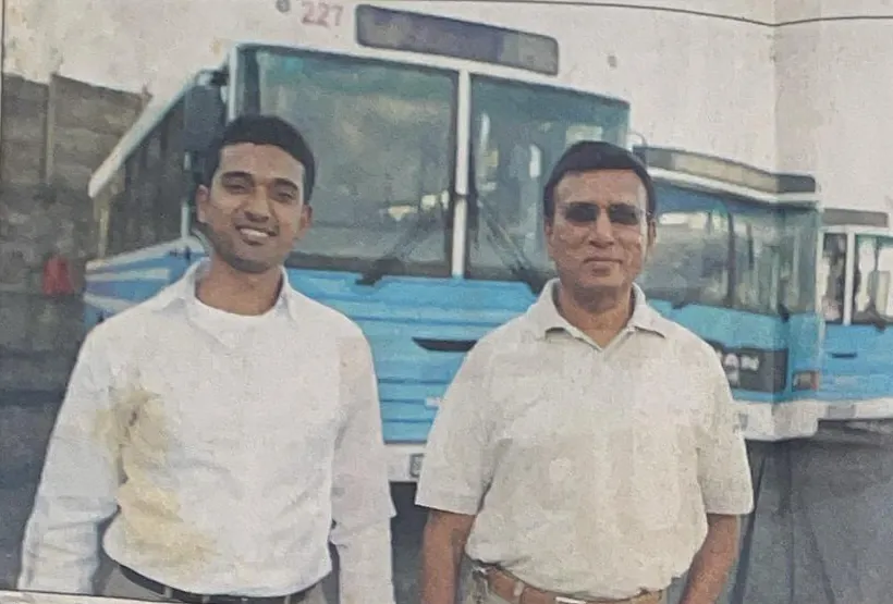 Vyasa and Pickey Dass standing in front of blue and white Dass buses